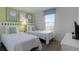 Bedroom with two twin beds and light green walls at 1638 Moon Valley Dr, Davenport, FL 33896