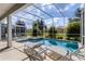 Screened pool and spa with plenty of lounge chairs at 1638 Moon Valley Dr, Davenport, FL 33896