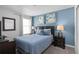 Bedroom with queen bed and blue accent wall at 1638 Moon Valley Dr, Davenport, FL 33896