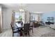 Bright dining room with a large wooden table and comfortable seating for eight at 1638 Moon Valley Dr, Davenport, FL 33896