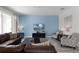 Living room with sectional sofa, two armchairs, and a large TV at 1638 Moon Valley Dr, Davenport, FL 33896