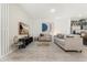 Spacious living room with neutral colored couch and patterned accent wall at 2163 Copper Bell Pl, Kissimmee, FL 34747