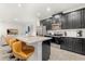 Modern kitchen with island seating, stainless steel appliances, and dark cabinets at 2163 Copper Bell Pl, Kissimmee, FL 34747