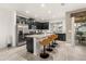 Modern kitchen with dark cabinetry, stainless steel appliances and an island, view of dining room at 2163 Copper Bell Pl, Kissimmee, FL 34747