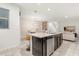 Open kitchen features an island with seating, dark cabinets, and breakfast bar at 2163 Copper Bell Pl, Kissimmee, FL 34747