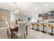 Open concept dining room with a wooden table and view of the kitchen at 2163 Copper Bell Pl, Kissimmee, FL 34747