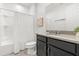 Clean bathroom, featuring a shower/tub combo, toilet and vanity with dark brown cabinets at 2163 Copper Bell Pl, Kissimmee, FL 34747