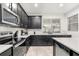 Modern kitchen with dark cabinetry, stainless steel appliances, and an island at 2163 Copper Bell Pl, Kissimmee, FL 34747