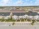 Aerial view of townhomes with parking and surrounding neighborhood at 2163 Copper Bell Pl, Kissimmee, FL 34747