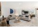 Open concept living room with neutral colored couches and a view of the kitchen at 2163 Copper Bell Pl, Kissimmee, FL 34747