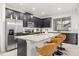 Modern kitchen with dark cabinetry, stainless steel appliances, and an island at 2163 Copper Bell Pl, Kissimmee, FL 34747
