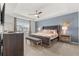 Spacious main bedroom with king-size bed and calming blue accent wall at 2163 Copper Bell Pl, Kissimmee, FL 34747