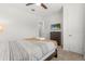 Bedroom with a striped bedspread, dresser, and mounted TV at 2163 Copper Bell Pl, Kissimmee, FL 34747