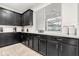 Modern kitchen with dark wood cabinets, quartz countertops, and a window at 2163 Copper Bell Pl, Kissimmee, FL 34747