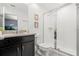 Clean bathroom, featuring a walk-in shower and dark brown vanity at 2163 Copper Bell Pl, Kissimmee, FL 34747