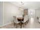 Bright dining room with a wooden table and six chairs, view of entryway at 2163 Copper Bell Pl, Kissimmee, FL 34747