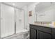 Clean bathroom with a walk-in shower, toilet and dark vanity at 2163 Copper Bell Pl, Kissimmee, FL 34747