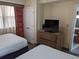 Bedroom with two double beds and a dresser with a TV on top at 12527 Floridays Resort Dr # 510E, Orlando, FL 32821