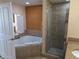 Large bathroom with corner jacuzzi tub and walk-in shower at 12527 Floridays Resort Dr # 510E, Orlando, FL 32821