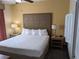 King-size bed, nightstands, and lamps in a comfortable bedroom at 12527 Floridays Resort Dr # 510E, Orlando, FL 32821