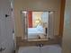 Bathroom with a bathtub and a view into a bedroom through a window at 12527 Floridays Resort Dr # 510E, Orlando, FL 32821