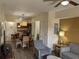 Spacious living room with seating area and view into kitchen and dining area at 12527 Floridays Resort Dr # 510E, Orlando, FL 32821