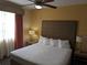 King-size bed, nightstands, and lamps in a spacious bedroom at 12527 Floridays Resort Dr # 510E, Orlando, FL 32821
