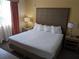 King-size bed, nightstands, and lamps in a well-lit bedroom at 12527 Floridays Resort Dr # 510E, Orlando, FL 32821
