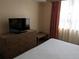 Bedroom with dresser, bench, and king-size bed at 12527 Floridays Resort Dr # 510E, Orlando, FL 32821