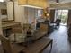 Open concept dining area with glass table and bench seating, adjacent to living room at 12527 Floridays Resort Dr # 510E, Orlando, FL 32821