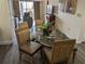 Bright dining area with glass table and four chairs, offering a view into the living room at 12527 Floridays Resort Dr # 510E, Orlando, FL 32821