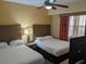 Bedroom with two double beds, a TV, and an adjacent closet at 12527 Floridays Resort Dr # 510E, Orlando, FL 32821