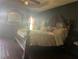 Main bedroom with large bed, dark wood furniture and green walls at 3635 Daydream Pl, Saint Cloud, FL 34772