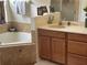 Bathroom with corner bathtub, double sink vanity, and separate shower at 3635 Daydream Pl, Saint Cloud, FL 34772