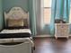 Bedroom with twin-size bed, white dresser, and light teal walls at 3635 Daydream Pl, Saint Cloud, FL 34772