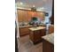 Kitchen with granite countertops, island, and wood cabinets at 3635 Daydream Pl, Saint Cloud, FL 34772