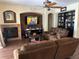 Gathering room with fireplace, built-in shelving and comfortable seating at 3635 Daydream Pl, Saint Cloud, FL 34772