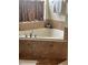 Bathroom with corner bathtub and beige tile flooring at 3635 Daydream Pl, Saint Cloud, FL 34772