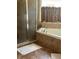 Bathroom with corner bathtub, shower, and beige tile at 3635 Daydream Pl, Saint Cloud, FL 34772