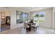 Dining room with glass-top table, view of bedroom and backyard at 4093 Giorgio Dr, Winter Haven, FL 33884