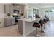 Modern kitchen with island, stainless steel appliances, and gray cabinets at 4093 Giorgio Dr, Winter Haven, FL 33884