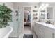 Bathroom with double vanity, walk-in shower, and bedroom view at 5525 Barma St, Orlando, FL 32807