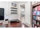 Home office with built-in shelves and view into living area at 5525 Barma St, Orlando, FL 32807
