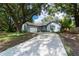 Light blue house with a large tree in the front yard at 5525 Barma St, Orlando, FL 32807