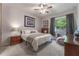 Bright bedroom with a queen-size bed, dresser, and large window at 5525 Barma St, Orlando, FL 32807