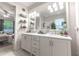 Double vanity bathroom with marble countertops and large mirror at 5525 Barma St, Orlando, FL 32807