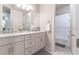 Elegant bathroom with double vanity, marble countertop, and a separate shower and tub at 5525 Barma St, Orlando, FL 32807