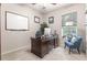 Spacious home office with a large desk, comfortable chair, and whiteboard at 5525 Barma St, Orlando, FL 32807
