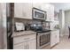 Modern kitchen with stainless steel appliances and granite countertops at 5525 Barma St, Orlando, FL 32807