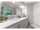 Bathroom with double vanity, marble countertop, and modern lighting at 5525 Barma St, Orlando, FL 32807